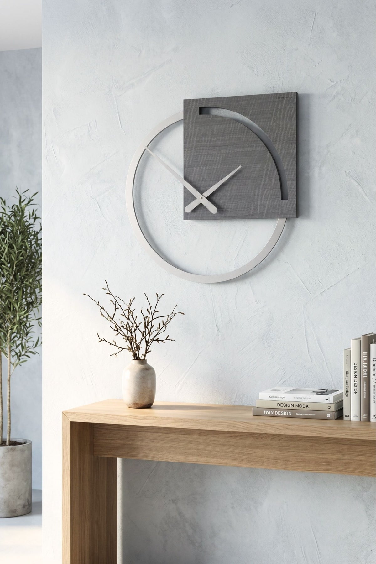 CalleaDesign Karl wall clock in Grey Burl finish above a wooden console in a bright contemporary interior