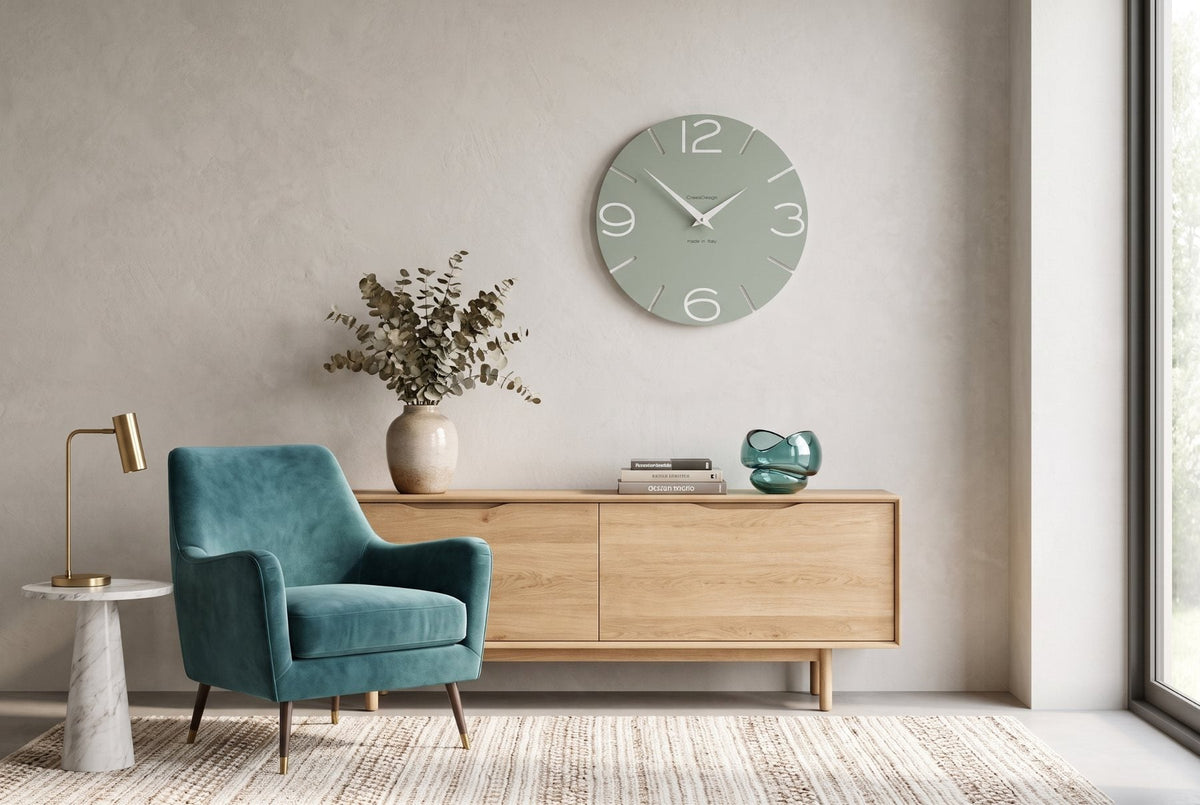 Sage green CalleaDesign wall clock with teal armchair in a contemporary interior