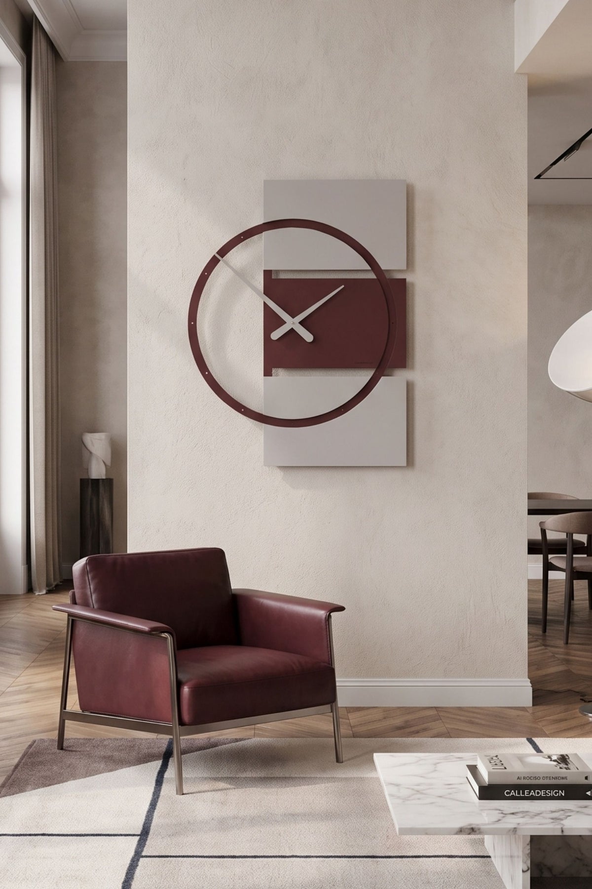 CalleaDesign Adam wall clock in Red Wine finish displayed in a modern living room