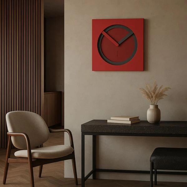 Red KAM Lava wall clock on a warm wall in a contemporary interior with a dark console