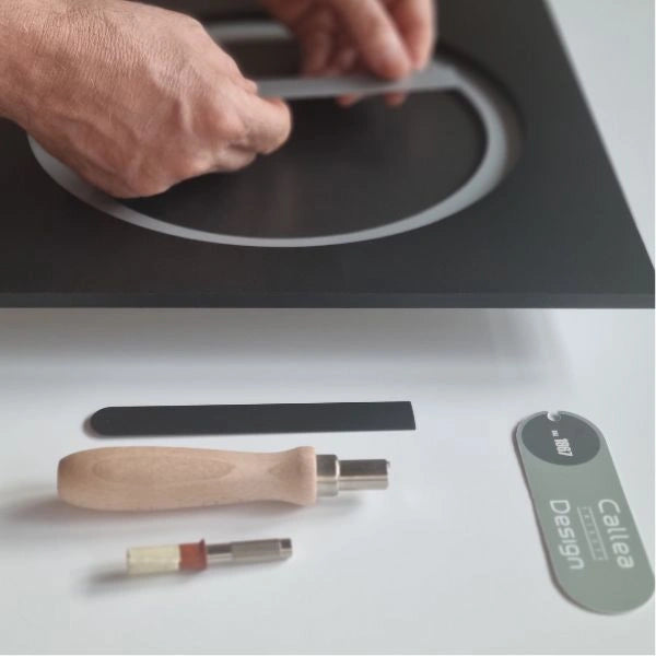 Hands assembling the circular detail of the KAM Notte wall clock in the Italian atelier